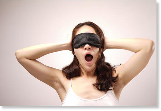 Blindfolded woman yawning