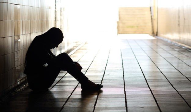 Sad person sitting alone