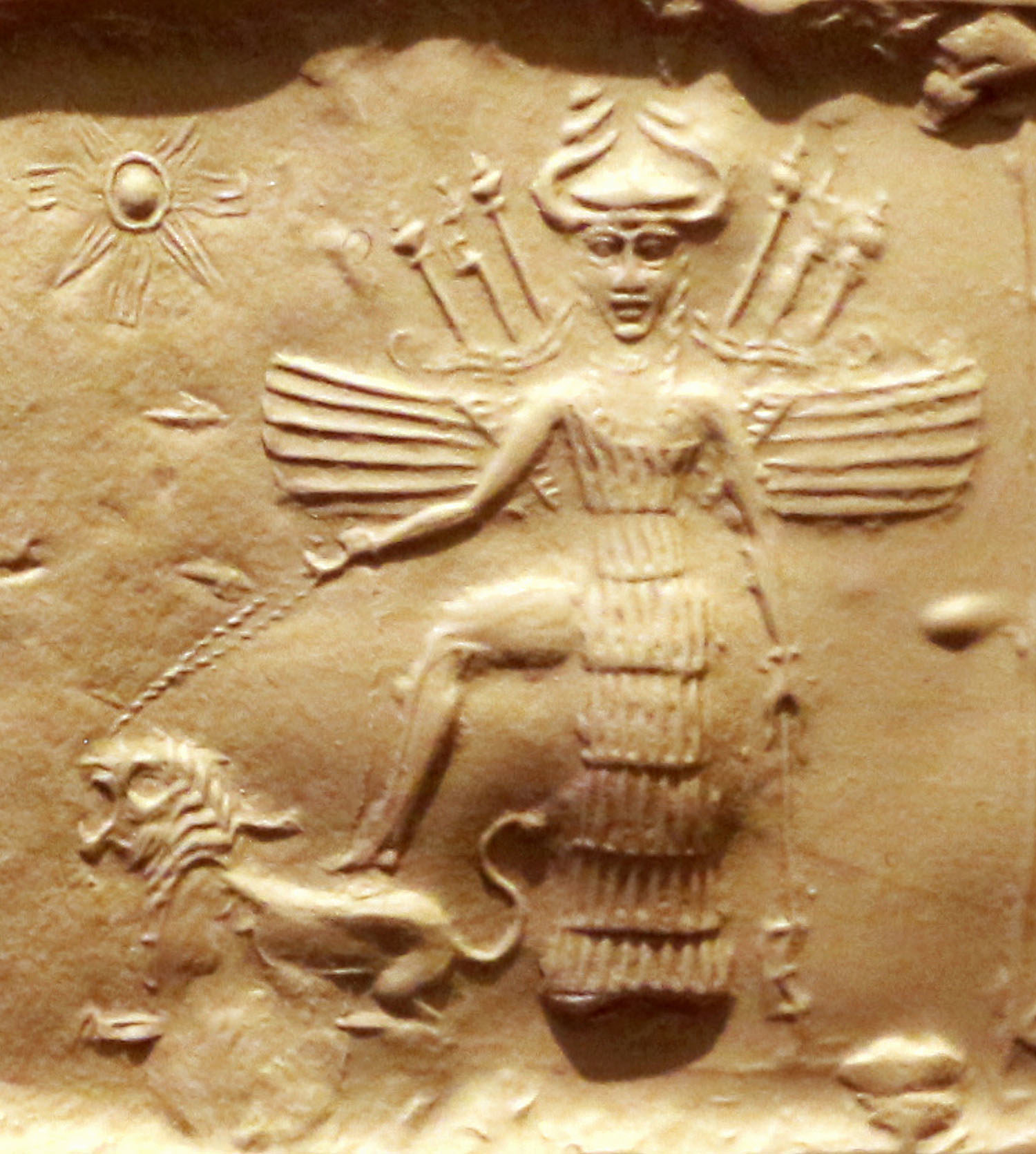 Innana on an Akkadian seal. She is equipped with 7 spears, a horned helmet and a 7 segments dress