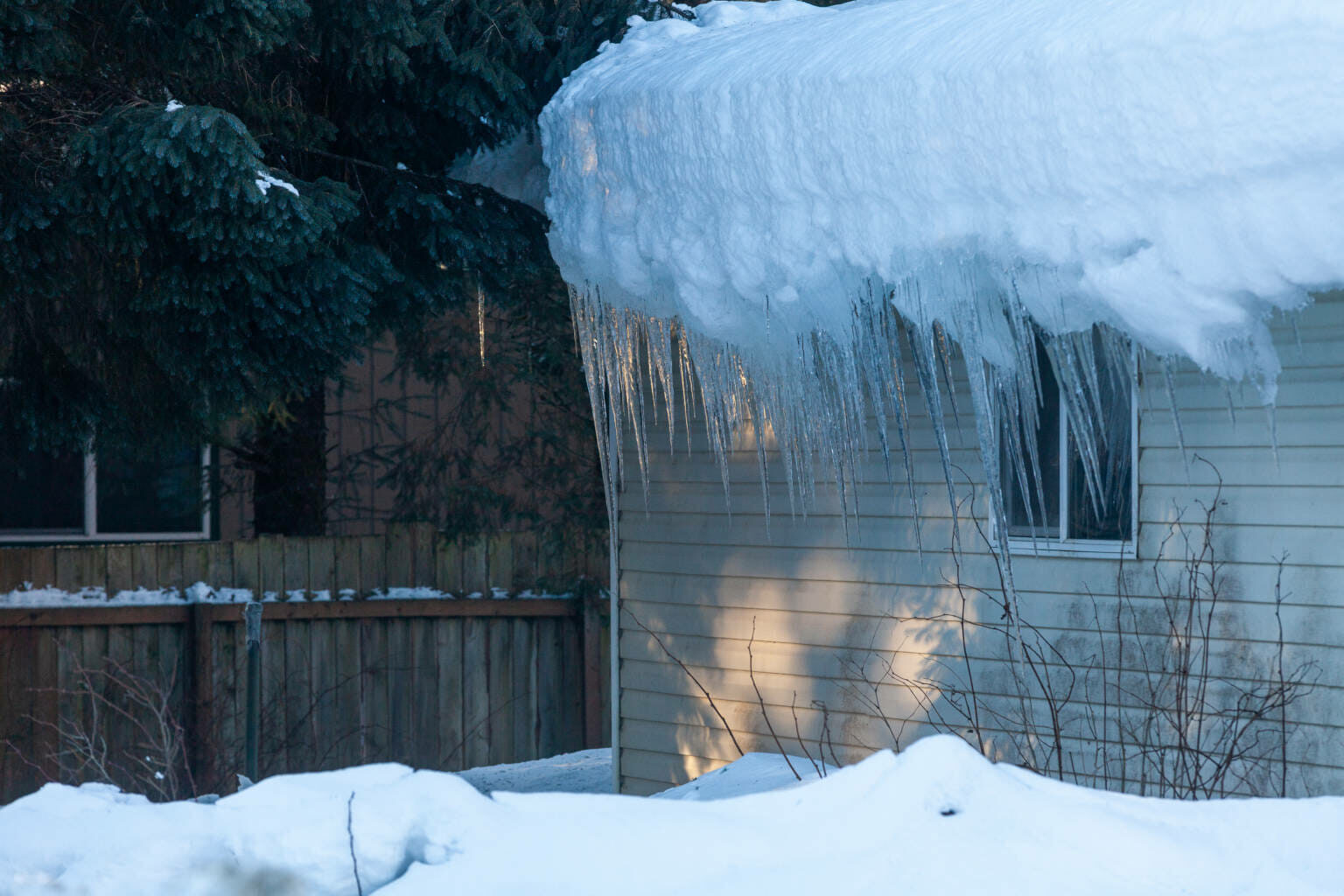 Ice hangs off of Stan Savland’s Lemon Creek home on Tuesday, Jan. 4, in Juneau.