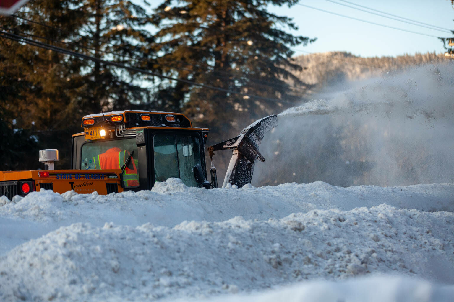 A state Department of Transportation worker clears snow from the sidewalk along the Glacier Highway in Lemon Creek on Tuesday, Jan. 4 in Juneau.