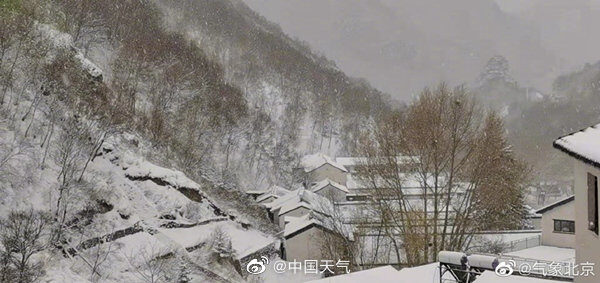 Photo taken on April 27, 2022, shows snow covering Lingshan Mountain area of Mentougou district in southwest of Beijing. Showers turned to snow in Beijing's southwestern mountain area on Wednesday morning.