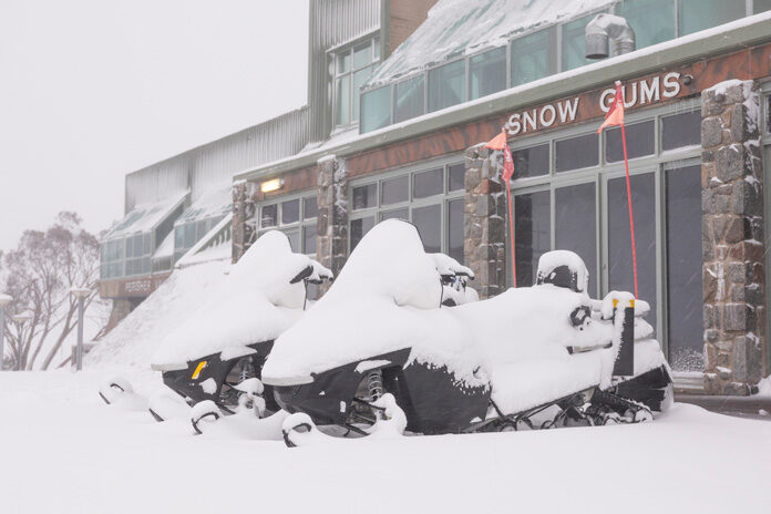 Snowmobiles all but swallowed up at Perisher, where 20cm fell in less than 24 hours.
