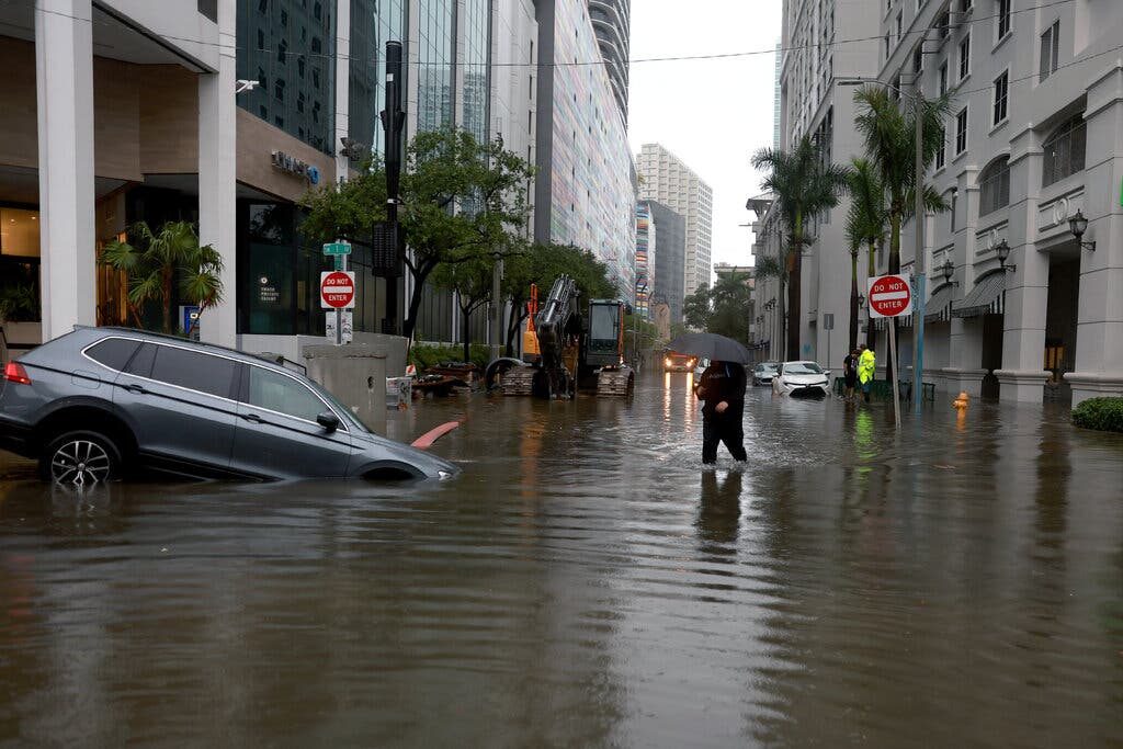 A pedestrian in a flooded street in Miami