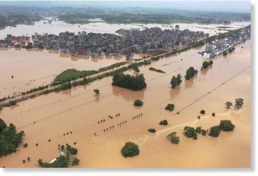 Floodwaters flow around a town in Shangrao in central China’s Jiangxi province