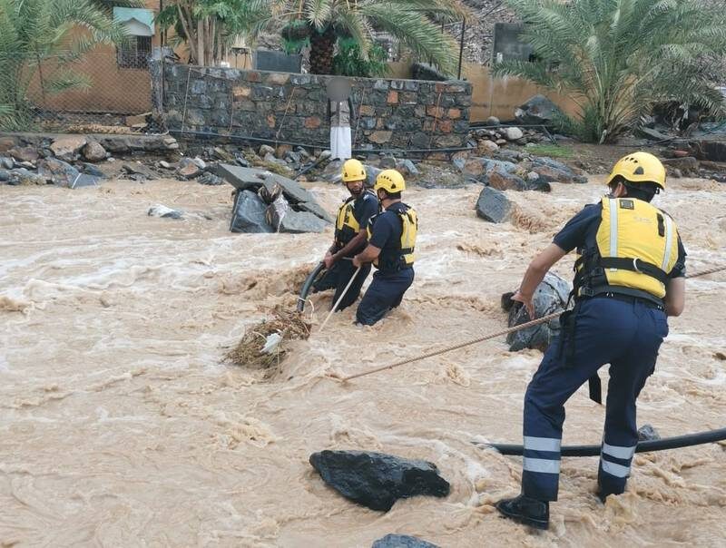 Rescue teams respond to a report of four people trapped in a house in the village of Jabal Shams.