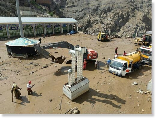 A handout picture provided by the Iranian Red Crescent shows members of a rescue team working at the site of a flash flood in the Emamzadeh Davoud northwestern part of Tehran, on July 28 2022.