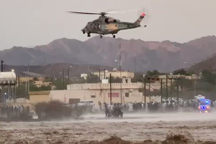 An Oman Police helicopter evacuates people stuck in the floods.