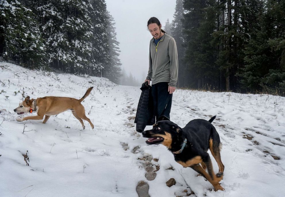 Chris Dugan, from Santa Fe, plays with his dogs at the Ski Santa Fe, on Oct. 17, 2022, in Sante Fe, N.M.