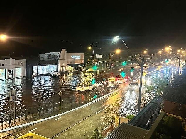 A sudden storm caused widespread flooding across Sydney on Tuesday night (pictured, vehicles travelling through floodwater in Manly)