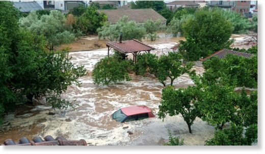 Floodwaters cover a car and the yards of houses in Milina village, Pilion region, central Greece, Tuesday, September 5, 2023.