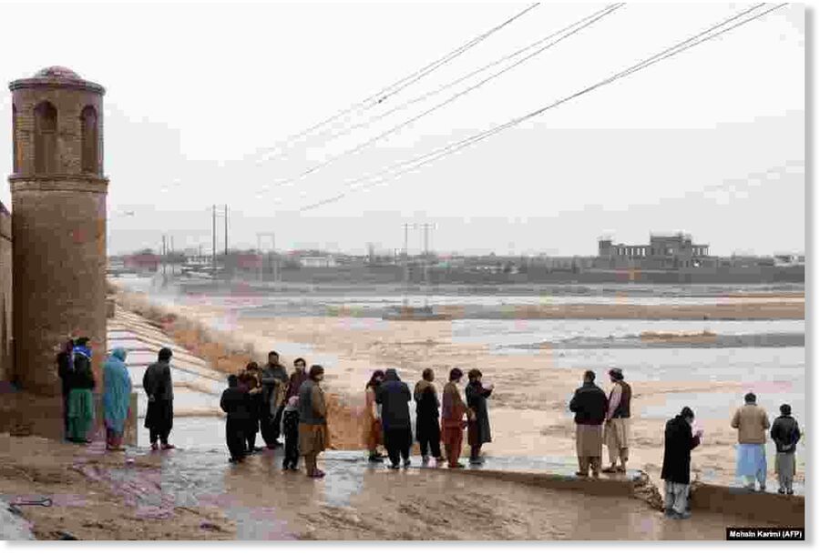 Afghan residents gather near the Pul-i-Malan bridge near the Hari Rud River following the flash floods on the outskirts of Herat on March 12.