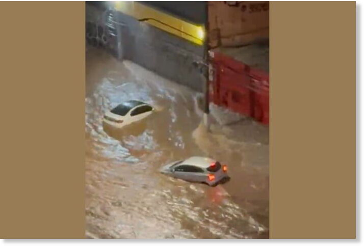 Rain sweeps cars down São Paulo avenue
