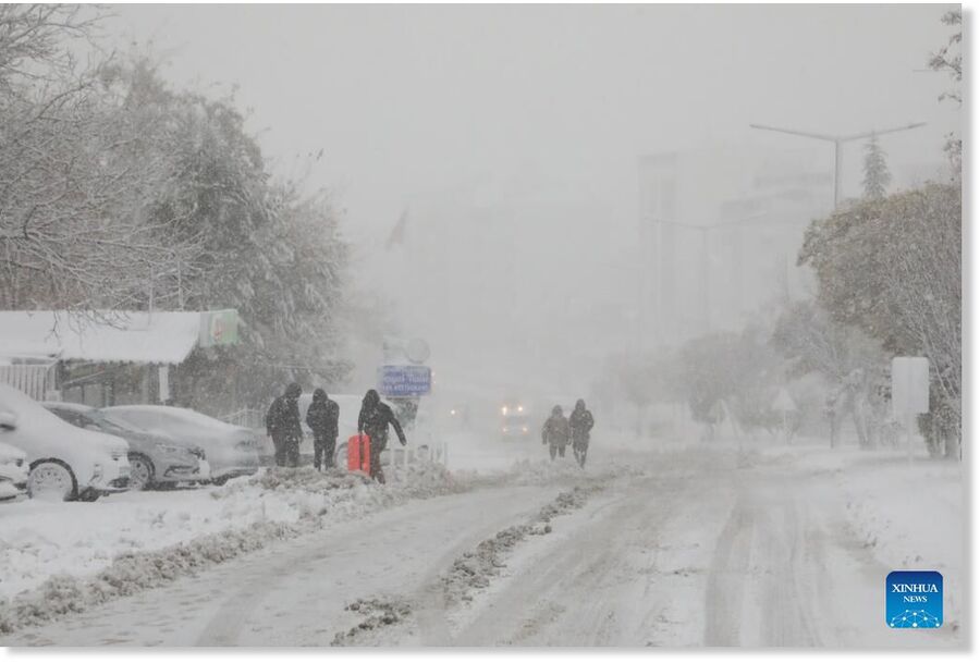 Klikni za povećanje People walk on a snow-covered road in Malatya, Türkiye, on March 21, 2025. Heavy snowfall has impacted Türkiye
