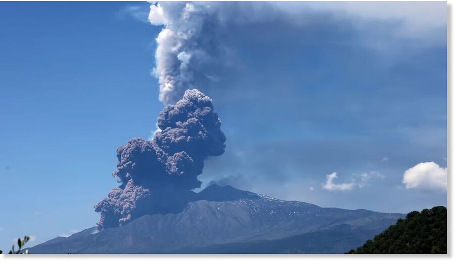 Volcanic steam and ashes rise from Mount Etna