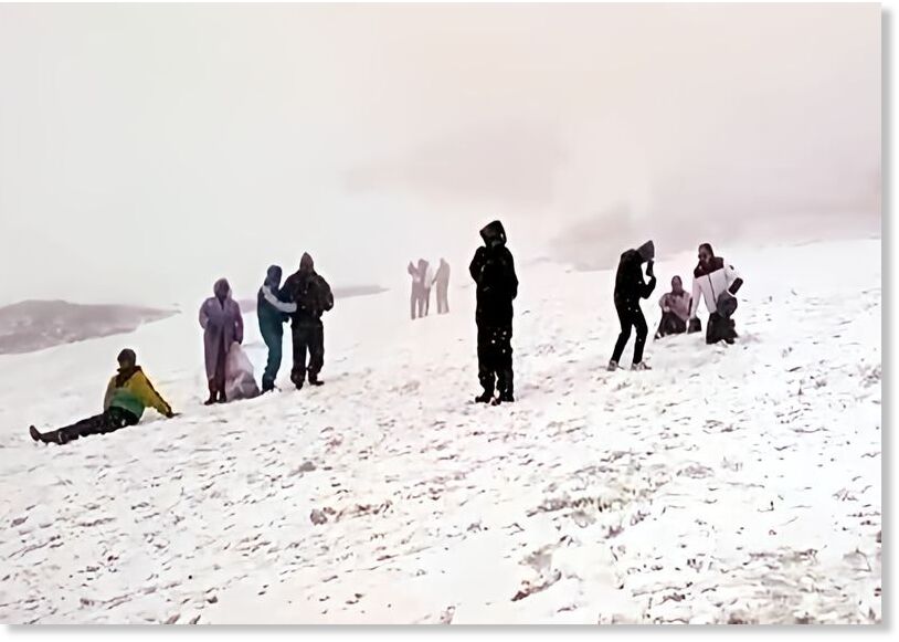 Winter surprise in June: Tourists play in the snow at Rohtang Pass near Manali.