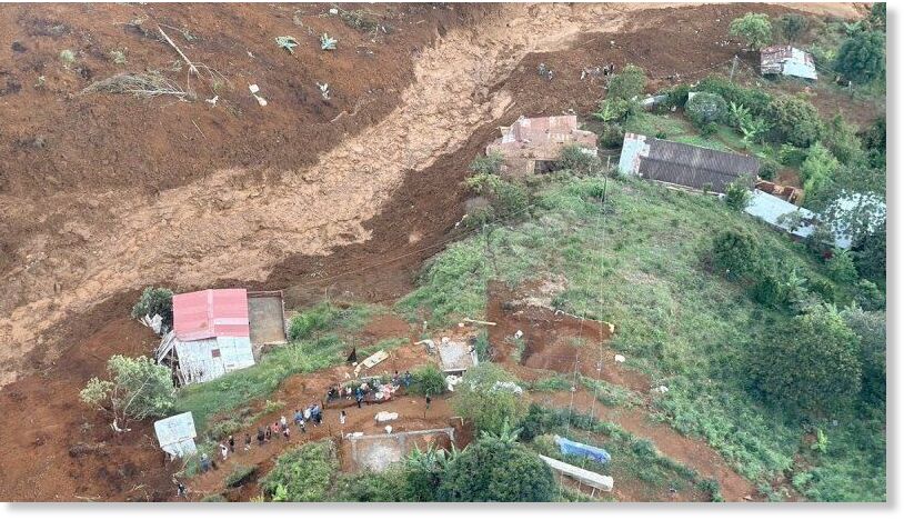 People gather at the site of a landslide in Bello, Antioquia, Colombia June 24, 2025.