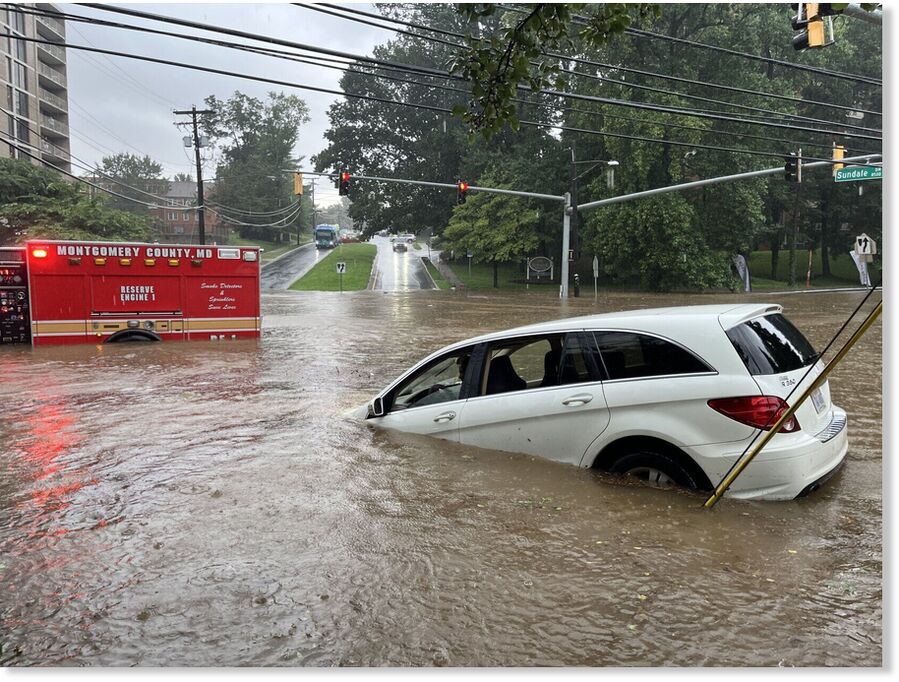 A vehicle and fire truck are flooded in Silver Spring, Maryland
