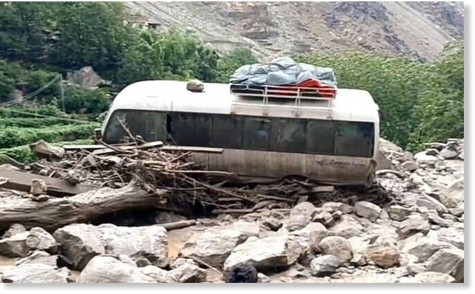 The screengrab taken from a video shows a bus being hit by a flash flood on Babusar Road in Pakistan’s northern Gilgit-Baltistan region on July 21, 2025.