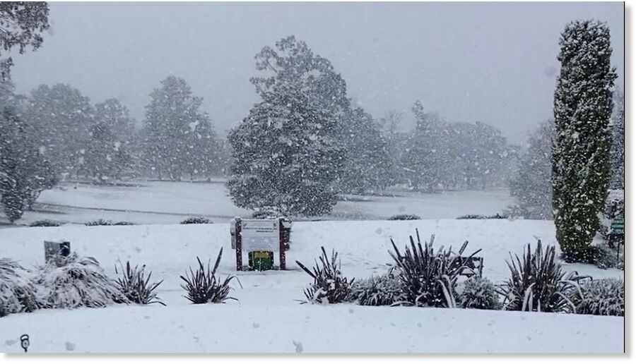 Snow blankets the grass at a Golf Club,
