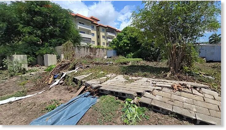 A homeowner’s wall lies in ruins in the Trafalgar Park community of New Kingston on Saturday after roaring water from a nearby gully came full force, downing the structure on Friday.