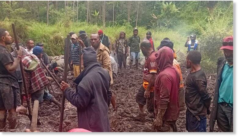 Villagers work to recover bodies after a landslide in Papua New Guinea's Enga province.