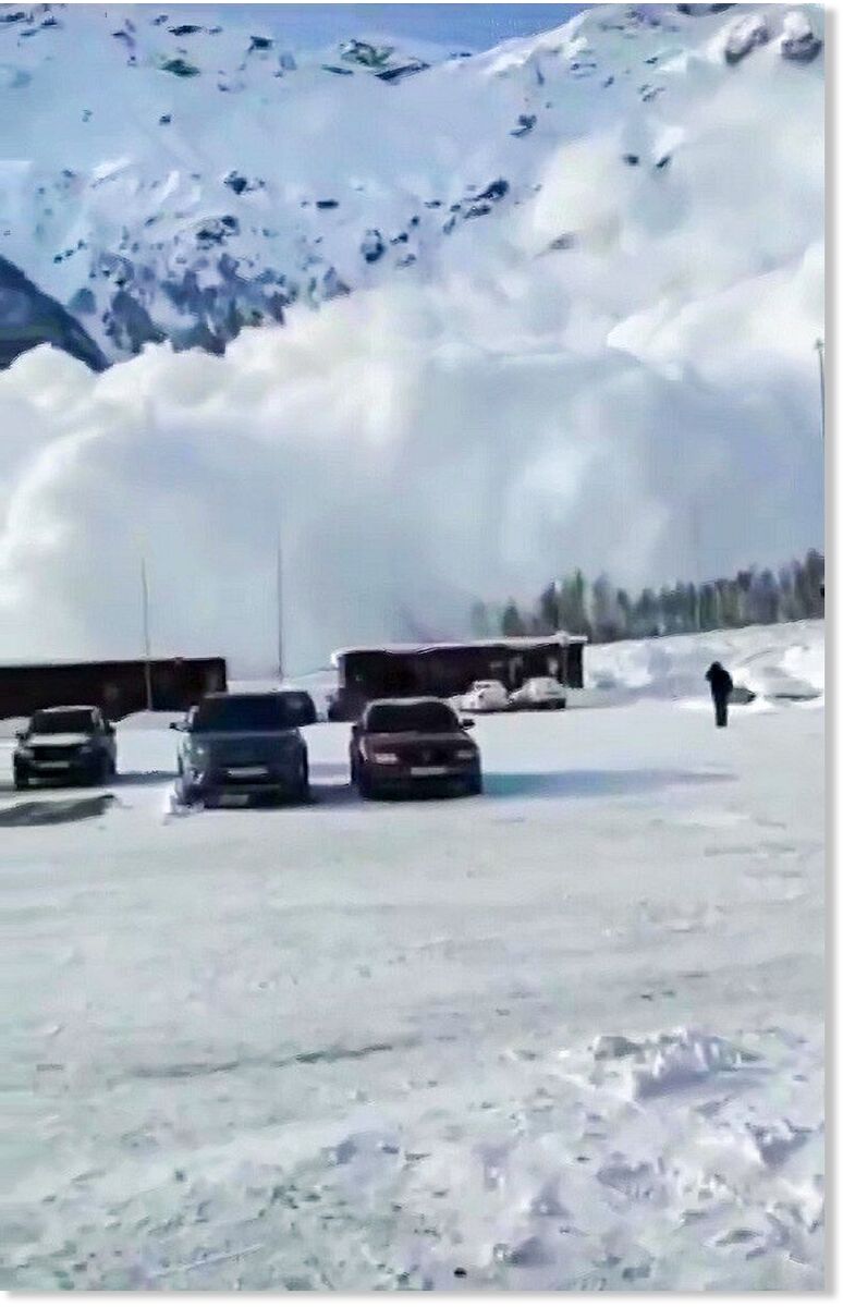 The avalanche devours everything in its path, including trees and cars
