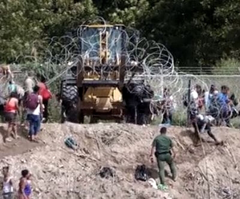 biden migrants border razor wire forklift