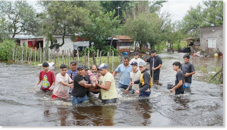 People rescue a man during a flood in Agua Azul, Tucumán Province, on March 11, 2026.